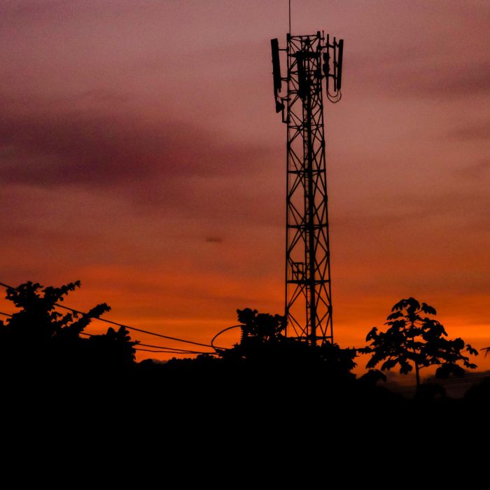 pexels-photo-10621828-10621828 A silhouette of a telecommunication tower against a dramatic sunset sky.